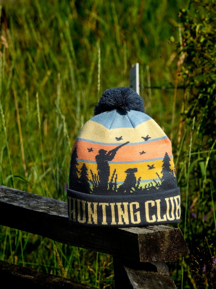 Hunting Club Knit Beanie Hat with Pom | Winter Outdoor Duck Hunting Dog Sunset Cap